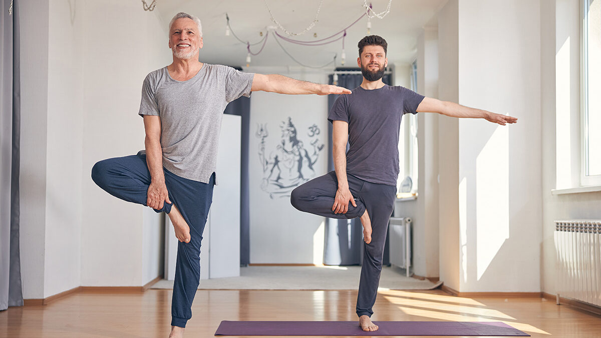 Two men balancing in yoga poses