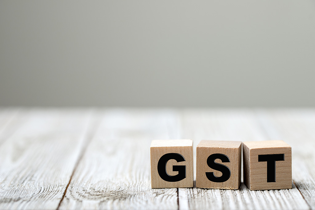 wooden blocks spelling out GST