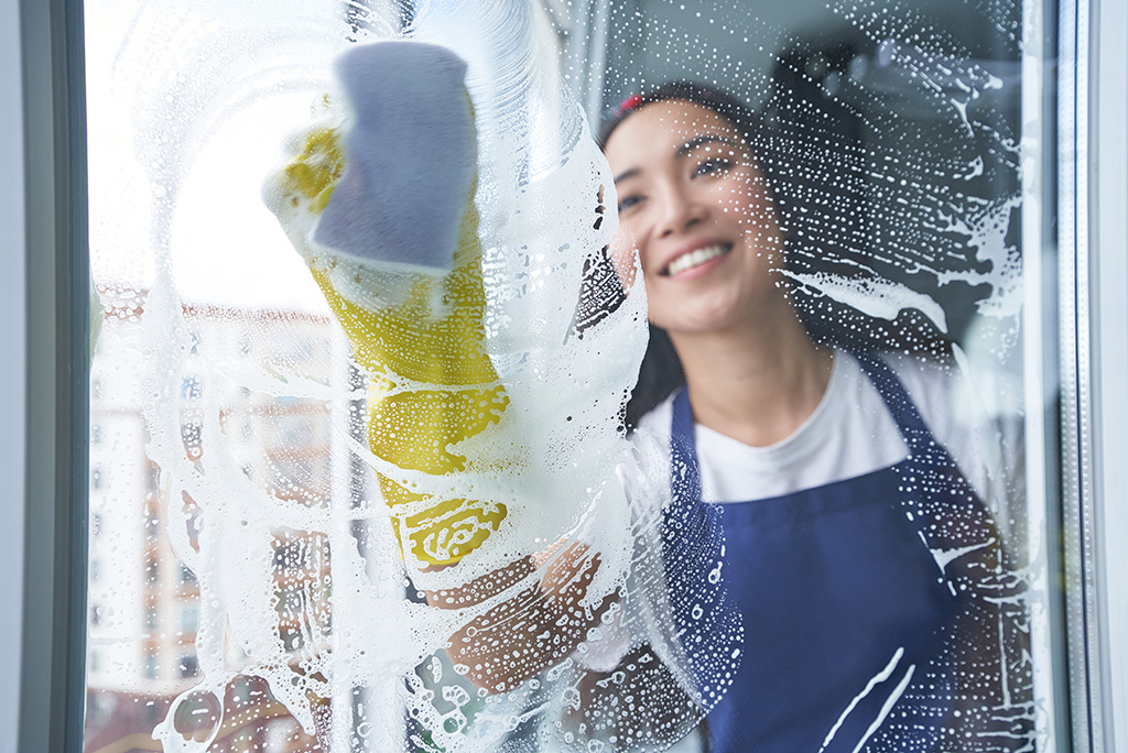 woman cleaning glass window