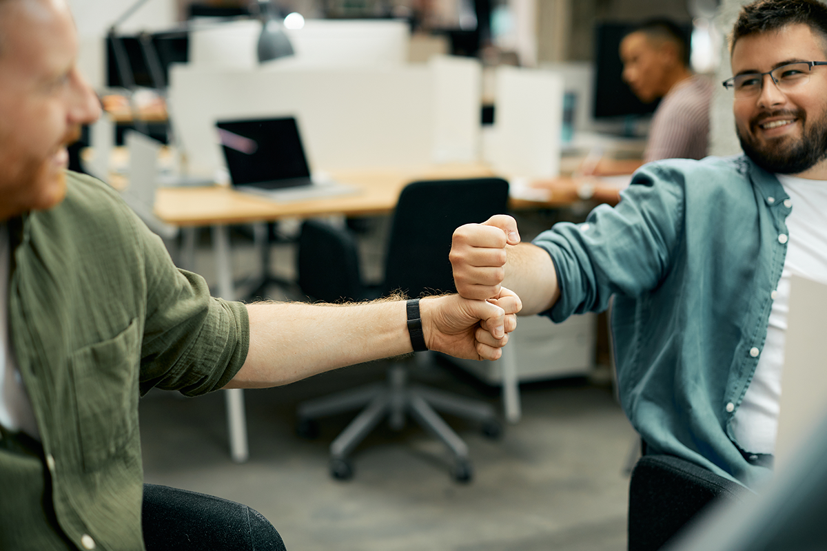 coworkers fist bumping