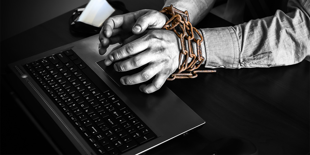 hands are trapped, tied to a computer