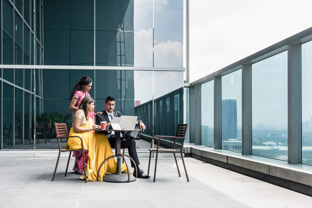 group of men and women working on balcony of a high-rise building