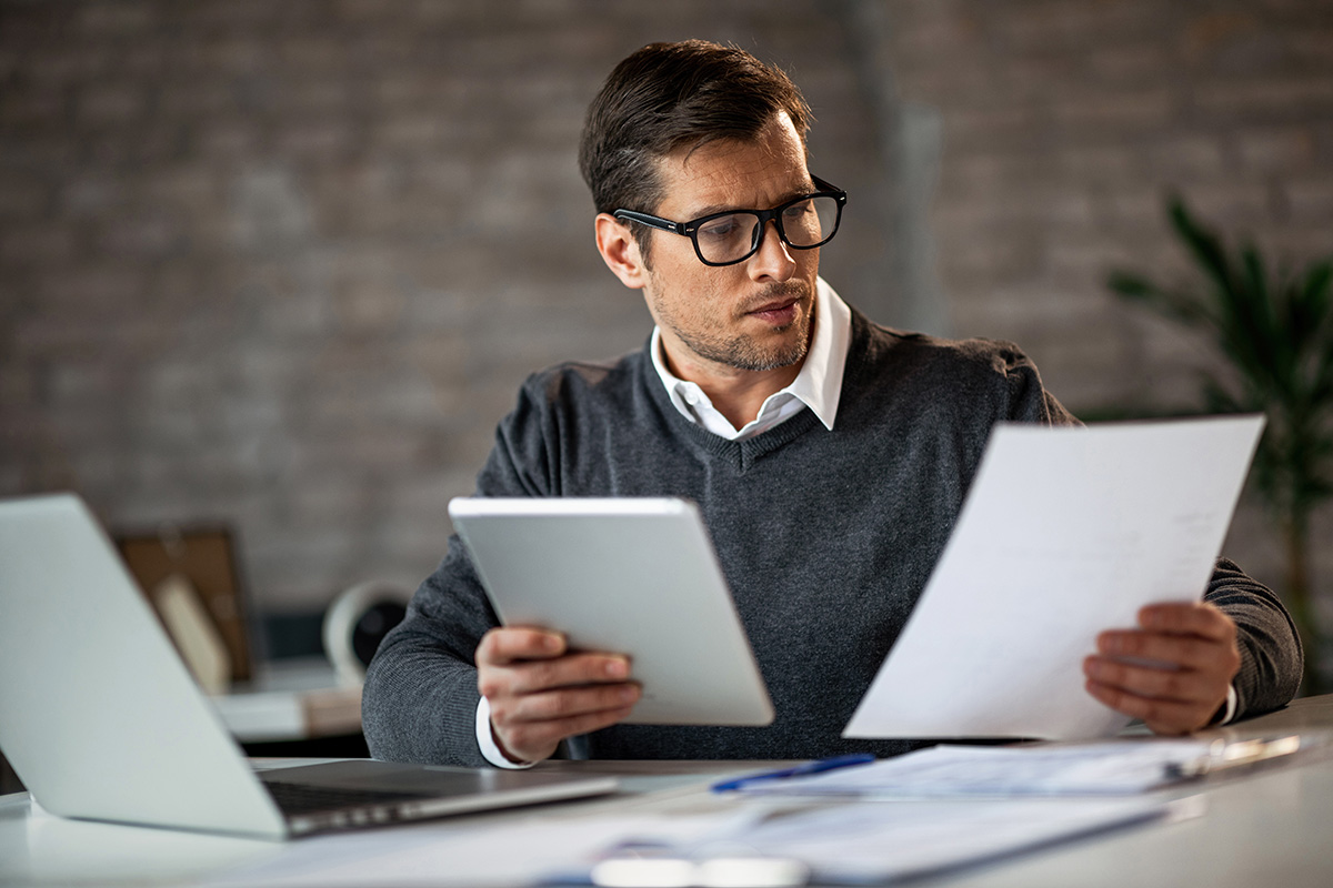Business man studying data on paper