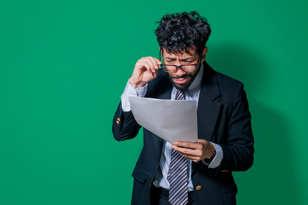 business man looking astounded while reading report