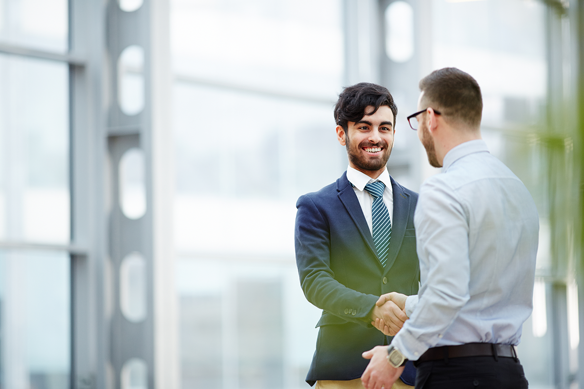 two happy business man shaking hands