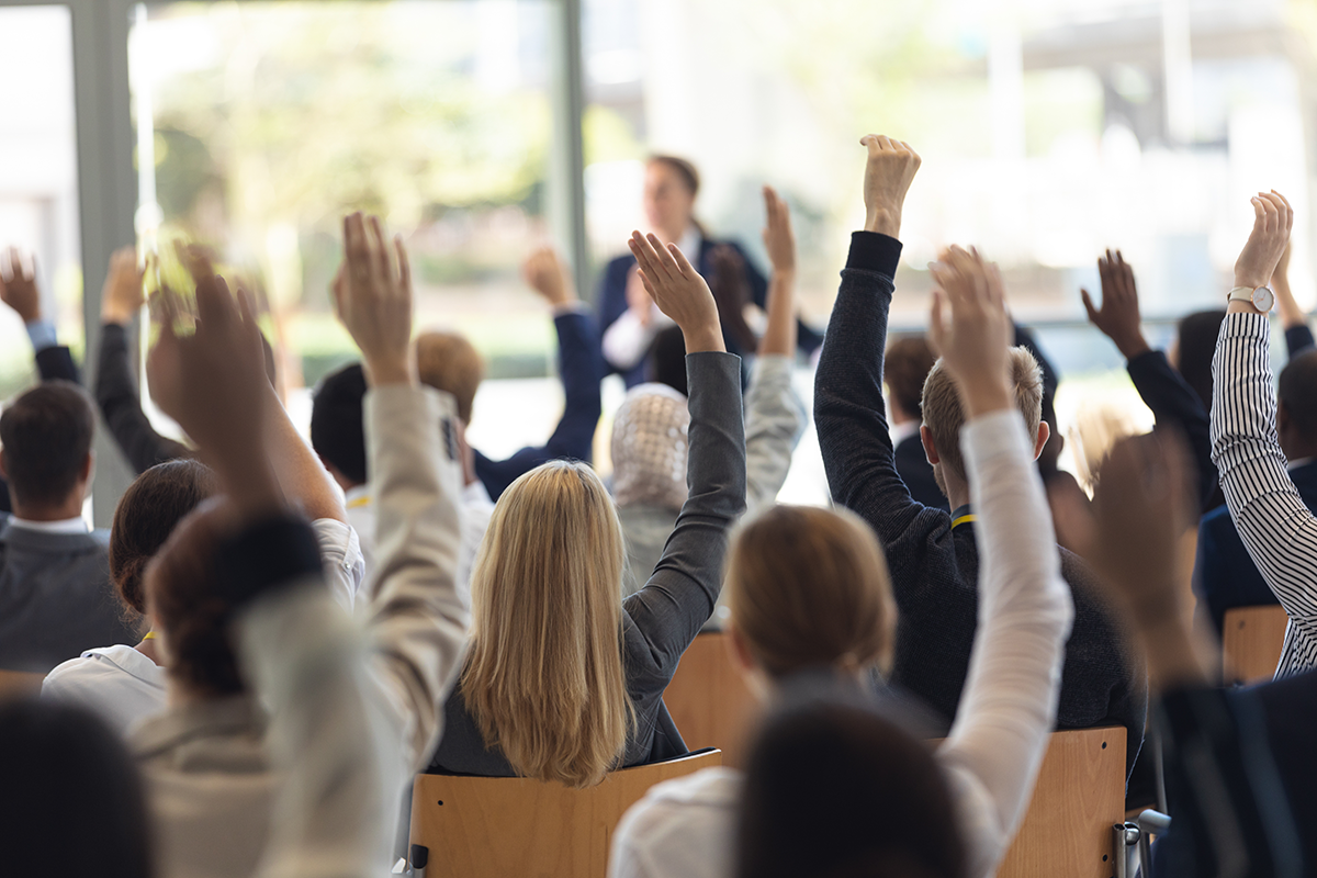 crowd raising hands