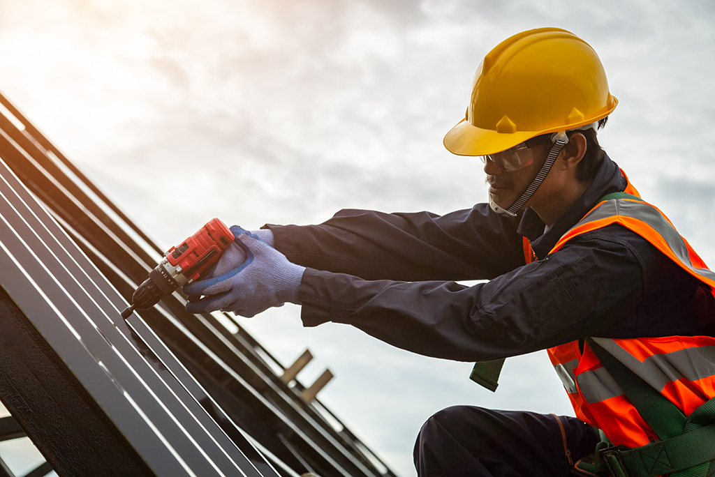 tradesman repairing roof of capital asset