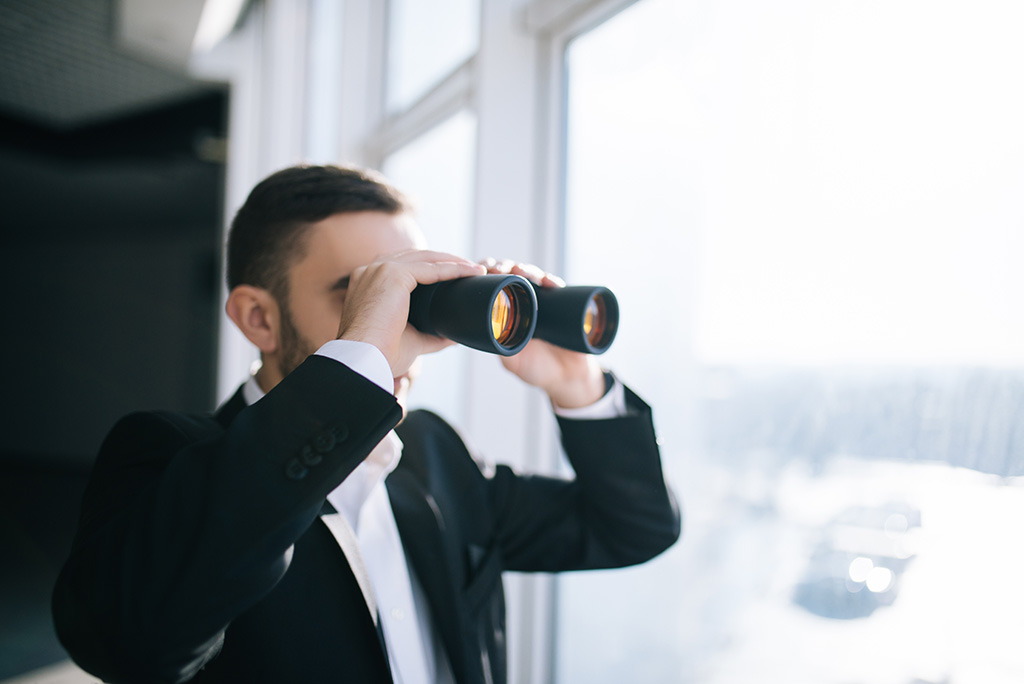 business man looking through binoculars