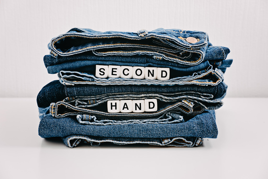 folded pile of secondhand jeans