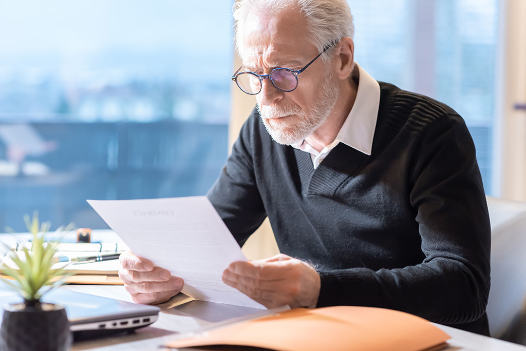 old businessman reading document