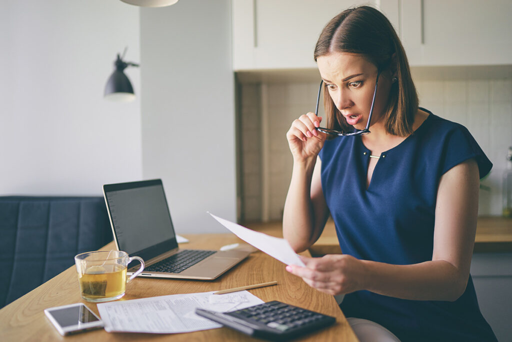 shocked woman reading a tax bill